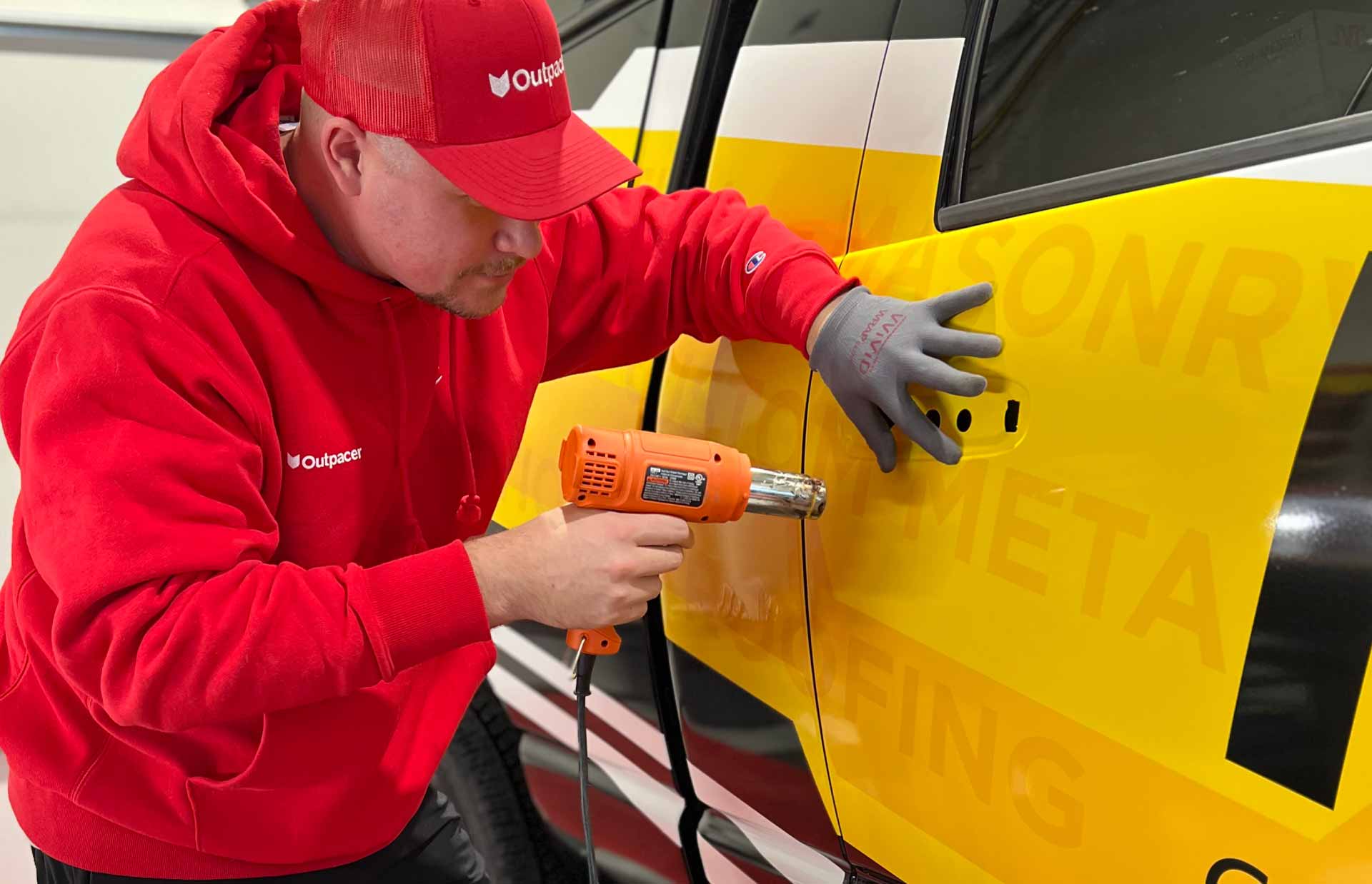 chris toms applying vinyl graphics to pickup truck